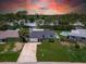 Aerial view of a home with a well-manicured lawn and an in-ground swimming pool at 4518 Helena Ne St, St Petersburg, FL 33703