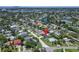 Wide aerial view displays a serene neighborhood, green spaces, and proximity to the intercoastal waterway and beaches; location marked at 4518 Helena Ne St, St Petersburg, FL 33703