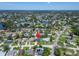 Expansive aerial view shows the neighborhood's layout, showcasing lush greenery, waterways, and community amenities; location marked at 4518 Helena Ne St, St Petersburg, FL 33703