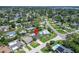 An aerial view showcases the neighborhood with its mature trees and proximity to community amenities; location marked with a pin at 4518 Helena Ne St, St Petersburg, FL 33703