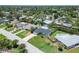 Aerial view of a home with a well-manicured lawn and an in-ground swimming pool at 4518 Helena Ne St, St Petersburg, FL 33703