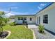 Backyard features a well-maintained lawn, white exterior, and patio at 4518 Helena Ne St, St Petersburg, FL 33703