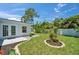 Charming backyard with privacy fence, mature landscaping, and outdoor patio at 4518 Helena Ne St, St Petersburg, FL 33703