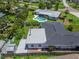 Aerial view displays the fenced backyard, patio, and lush landscaping at 4518 Helena Ne St, St Petersburg, FL 33703