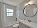 Bathroom features modern vanity, white subway tile, and shower with curtain at 4518 Helena Ne St, St Petersburg, FL 33703
