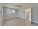 Spacious bedroom with ceiling fan, neutral gray walls, and access to a bathroom at 4518 Helena Ne St, St Petersburg, FL 33703
