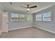 Bright bedroom features natural light, ceiling fan, and attractive gray toned flooring at 4518 Helena Ne St, St Petersburg, FL 33703