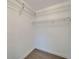 Walk-in closet features wood-look flooring and wire shelving for maximum storage capacity at 4518 Helena Ne St, St Petersburg, FL 33703