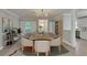 Bright dining room featuring hardwood floors, modern light fixture, and seating for eight at 4518 Helena Ne St, St Petersburg, FL 33703