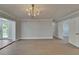 Dining room boasts wood floors, a modern chandelier, and easy access to an outside patio at 4518 Helena Ne St, St Petersburg, FL 33703