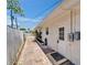 Side of home featuring a brick path and white fence at 4518 Helena Ne St, St Petersburg, FL 33703