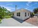 Exterior view of the white home, highlighting the gray patio and chimney at 4518 Helena Ne St, St Petersburg, FL 33703