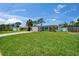 Well-maintained home with green lawn, palm trees, and an attached garage at 4518 Helena Ne St, St Petersburg, FL 33703