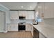 Kitchen features white cabinetry, stainless steel appliances, and a modern backsplash at 4518 Helena Ne St, St Petersburg, FL 33703