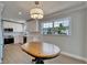 Bright kitchen features white cabinetry, stainless appliances, and a modern light fixture at 4518 Helena Ne St, St Petersburg, FL 33703
