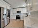 Kitchen features stainless steel appliances, white cabinets, and stone countertops at 4518 Helena Ne St, St Petersburg, FL 33703
