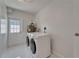 Laundry room with white washer and dryer, utility sink, and access to the backyard at 4518 Helena Ne St, St Petersburg, FL 33703