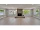 Living room showcasing a modern tiled fireplace, recessed lights, and wood look floors at 4518 Helena Ne St, St Petersburg, FL 33703