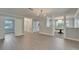 Spacious living room featuring hardwood floors, fresh paint, and abundant natural light at 4518 Helena Ne St, St Petersburg, FL 33703