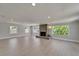 Spacious living room with wood flooring, recessed lighting, and a stunning tiled fireplace at 4518 Helena Ne St, St Petersburg, FL 33703