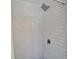 Contemporary shower features sleek white subway tile and a modern shower head at 4518 Helena Ne St, St Petersburg, FL 33703