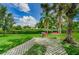 Complex lawn area with walking stones, bench, and lush landscaping at 4580 Overlook Ne Dr # 191, St Petersburg, FL 33703