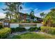Landscaped entrance to Lake Overlook Condominiums features a brick sign and well-maintained greenery under a bright blue sky at 4580 Overlook Ne Dr # 191, St Petersburg, FL 33703