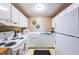 Functional kitchen featuring white appliances, ample countertop space, and sufficient cabinet storage for an organized cooking experience at 4580 Overlook Ne Dr # 191, St Petersburg, FL 33703