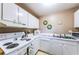 Functional kitchen featuring white appliances, ample countertop space, and sufficient cabinet storage for an organized cooking experience at 4580 Overlook Ne Dr # 191, St Petersburg, FL 33703