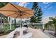 Outdoor patio area with a barbecue grill, umbrella-covered table, and ample seating, ideal for enjoying outdoor meals and gatherings at 4580 Overlook Ne Dr # 191, St Petersburg, FL 33703