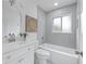 Well-lit bathroom features modern vanity, tiled bathtub, and contemporary fixtures at 4753 58Th N St, Kenneth City, FL 33709