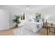 Well-lit bedroom with a neutral color scheme, wood floors, and stylish decor at 4753 58Th N St, Kenneth City, FL 33709