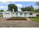 Charming home with solar panels, bright shutters, neat landscaping, and covered entry at 4753 58Th N St, Kenneth City, FL 33709