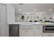 Bright kitchen with a farm sink, white cabinets, and modern appliances at 4753 58Th N St, Kenneth City, FL 33709