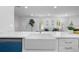 Bright, open kitchen view shows details such as a farm sink, stainless appliances, and recessed lighting at 4753 58Th N St, Kenneth City, FL 33709