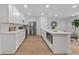 Well-lit kitchen with white cabinets, stainless steel appliances, and island at 4753 58Th N St, Kenneth City, FL 33709