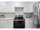 Bright kitchen features white cabinetry, stainless steel appliances, and modern finishes at 4753 58Th N St, Kenneth City, FL 33709