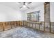 Bedroom with a large window for natural light under renovation with cement walls at 489 W Davis Blvd, Tampa, FL 33606