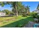 Spacious front yard featuring a well-manicured lawn, mature trees, and a serene neighborhood setting at 489 W Davis Blvd, Tampa, FL 33606