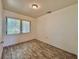 Serene bedroom with wood-look floors, a large window, and ample natural light for a restful ambiance at 4906 N Arrawana Ave, Tampa, FL 33614