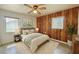Serene bedroom with wood-paneled wall, soft lighting, and a comfortable bed, creating a tranquil space at 4906 N Arrawana Ave, Tampa, FL 33614