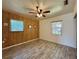 Spacious bedroom featuring natural light, wood-look floors, and a ceiling fan for added comfort at 4906 N Arrawana Ave, Tampa, FL 33614