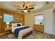 Cozy bedroom with wood-paneled walls, a ceiling fan, and a comfortable bed, perfect for relaxation at 4906 N Arrawana Ave, Tampa, FL 33614