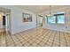 Bright dining room showcasing classic tile flooring and a charming chandelier, ideal for Gathering meals at 4906 N Arrawana Ave, Tampa, FL 33614