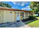 Well-maintained home exterior featuring a brick facade, tidy landscaping, and a welcoming front entrance at 4906 N Arrawana Ave, Tampa, FL 33614
