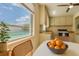 Cozy kitchen with a view of the pool and a bowl of oranges on the table at 4906 N Arrawana Ave, Tampa, FL 33614