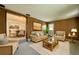 Inviting living room with wood paneling, comfortable seating, and an open doorway to the dining room at 4906 N Arrawana Ave, Tampa, FL 33614