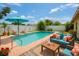 This backyard boasts a sparkling pool surrounded by lounge seating, perfect for relaxing and entertaining at 4906 N Arrawana Ave, Tampa, FL 33614