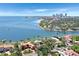 Waterfront home with bay views, palm trees, a brick patio, and lush landscaping at 501 Brightwaters Ne Blvd, St Petersburg, FL 33704