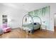 Spacious bedroom with a metal canopy bed and hardwood floors at 501 Brightwaters Ne Blvd, St Petersburg, FL 33704
